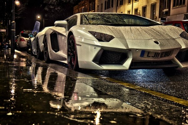 A luxury car standing on wet asphalt