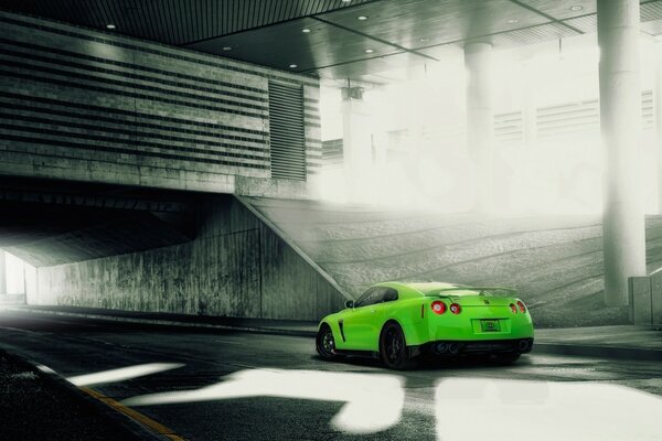 A green sports car pulls into a tunnel