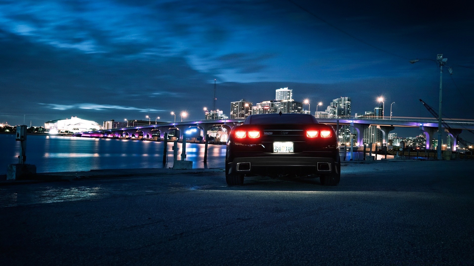 cars car transportation system city travel street road vehicle light sunset dusk evening traffic sea water bridge urban blur cityscape building sky