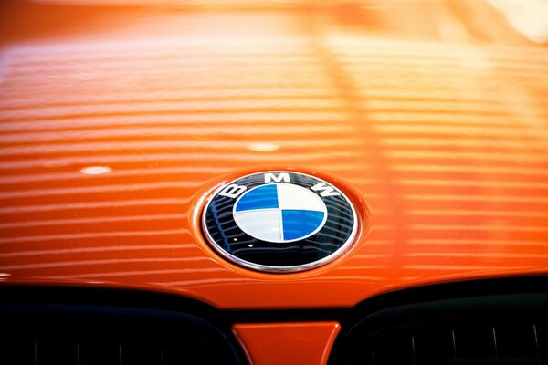 BMW car badge on an orange background