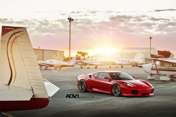 Red Ferrari and white planes