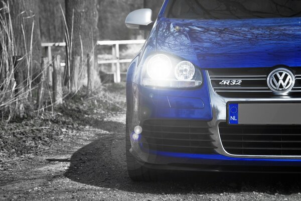 Bright headlight of a blue Volkswagen