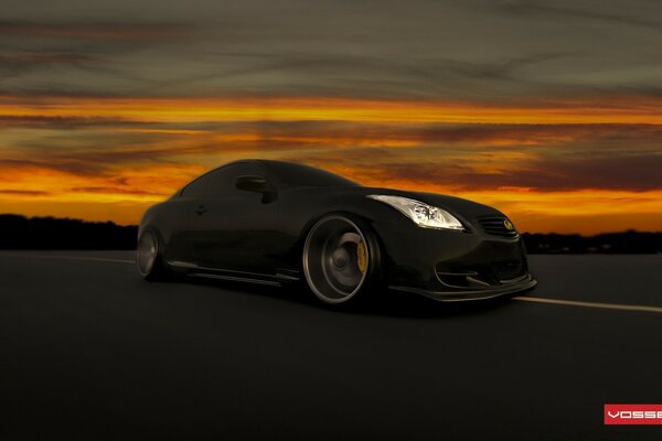 Black car on sunset background