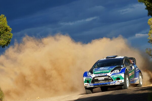 Racing car in a cloud of dust