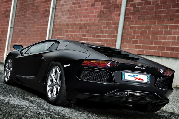 Black beautiful car standing on the sidewalk