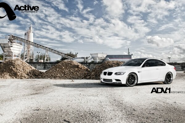 White car on the background of a quarry