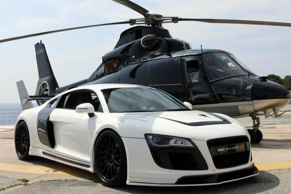 A white car and a black helicopter