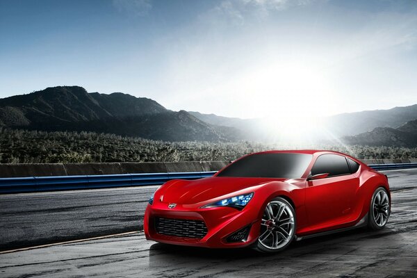 Beautiful red car on the background of mountains