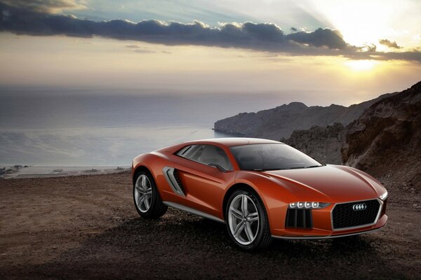 Luxury car on the beach in the sunset