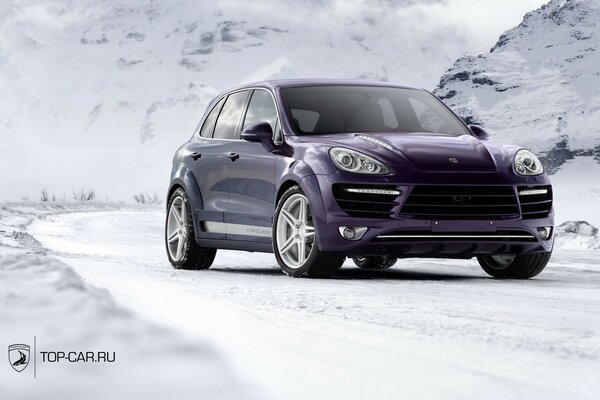 Purple car on the background of snowy mountains