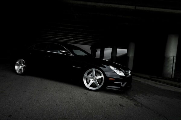 A black car in a black tunnel