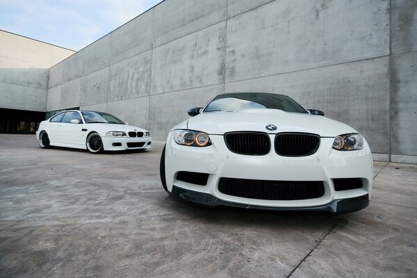 Two white BMWs