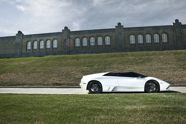 White sports car on the background of the fortress