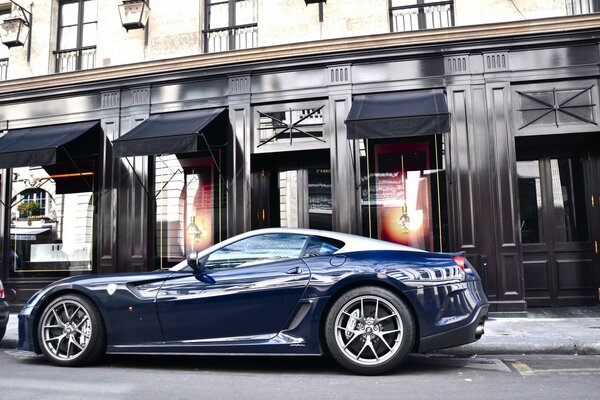 Modern and powerful car, on the background of a beautiful house