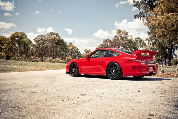 A red car is standing on the road