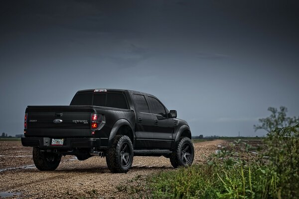 Staged photo of a pickup truck on a dirt road