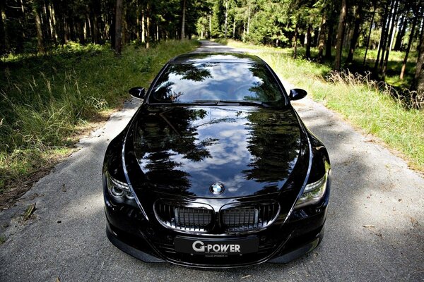 Foto di un auto nera aggressiva nella foresta