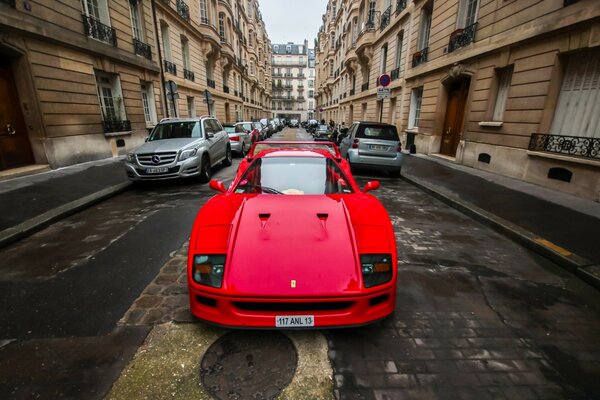 A red car on a narrow street