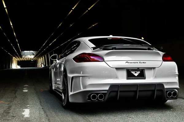 A sports car in a tunnel with a backlit light