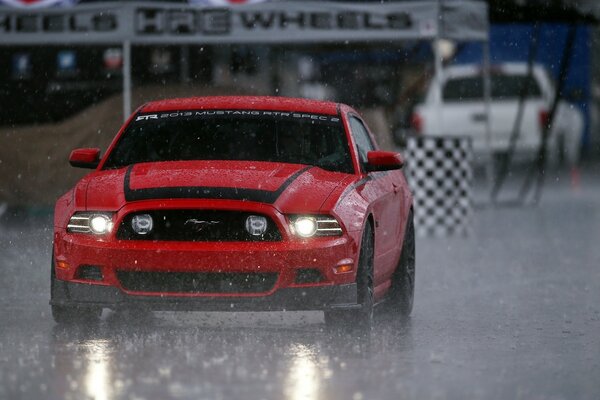 Red sports car in rainy weather