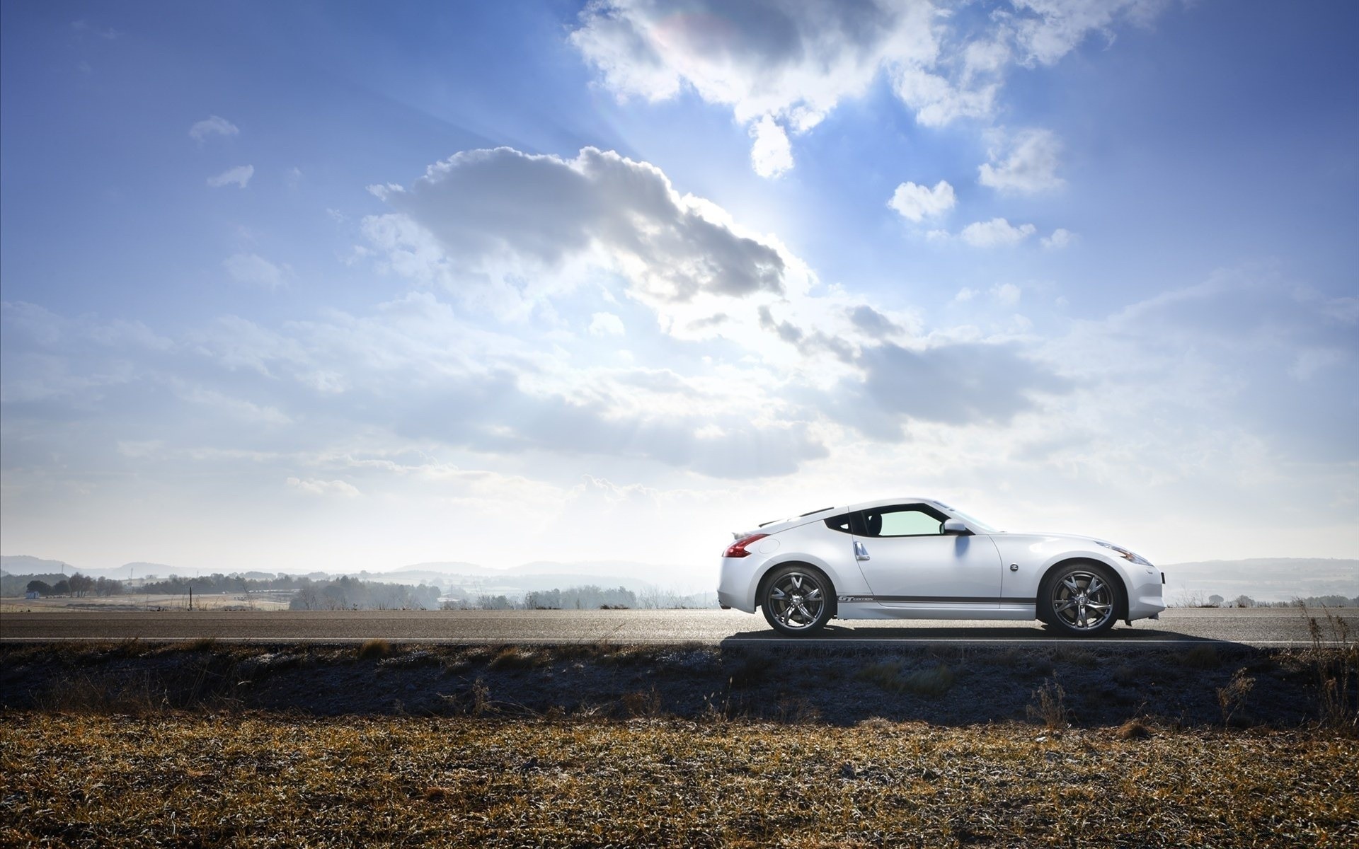 cars landscape sky vehicle travel outdoors sunset road nature field car grass light