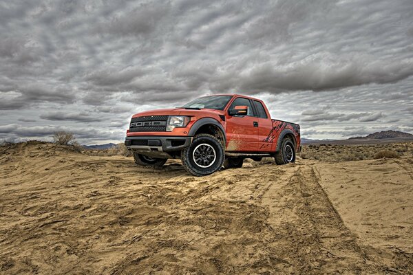 A car in the desert. Red car