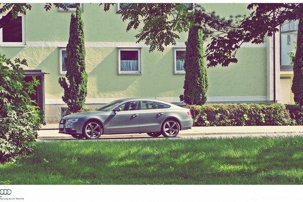 An extravagant sedan against a beautiful landscape