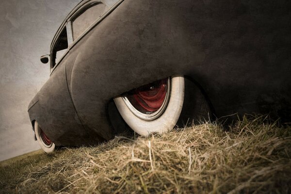 A black car on the hay in the field