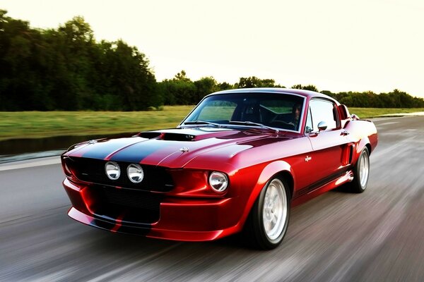 Red sedan on an empty highway