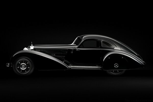 Black retro car on black background