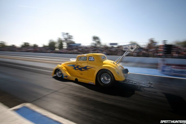 Yellow retro car flying on the highway