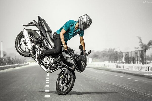 Motorcyclist wearing a helmet on a gray background