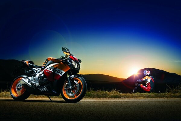 A motorcyclist enjoys the sunset