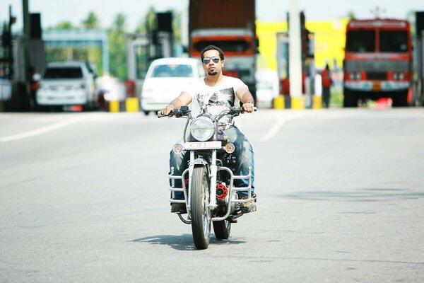 A man rides a motorcycle on the road