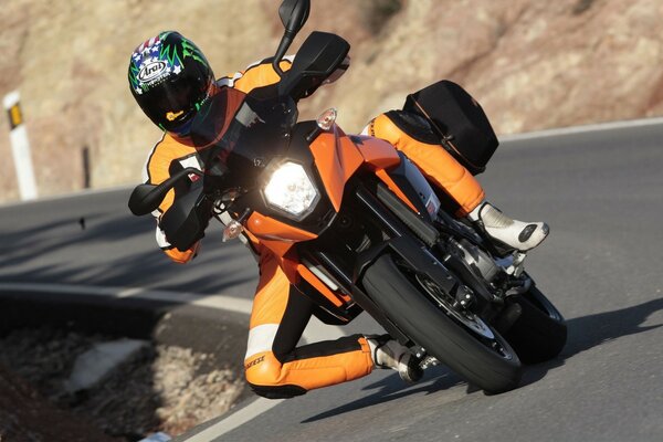 A MOTORCYCLIST ENTERS A SHARP TURN