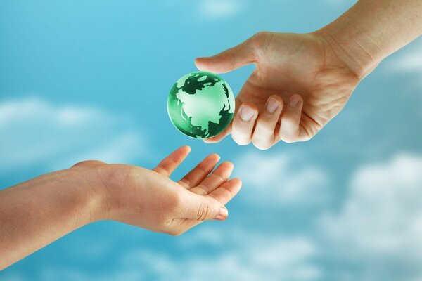 A green ball is passed from hand to hand