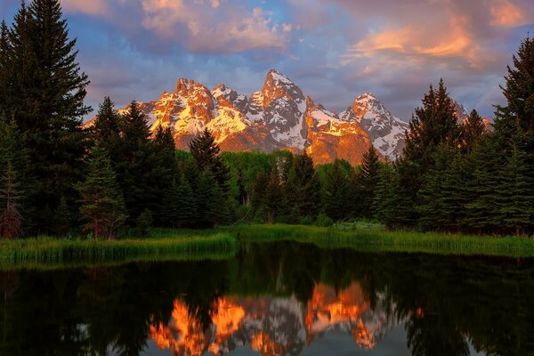 Beautiful mountain landscape. Sunset and dawn. River. Reflection in the river