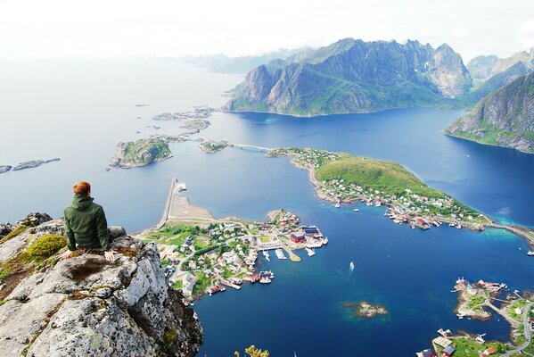 A man sitting on a rock. Mountain landscape. Sea