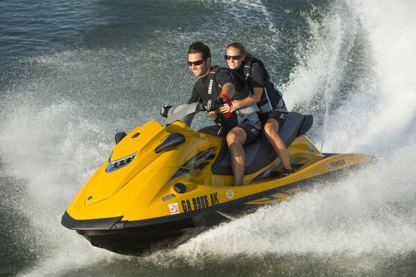 Two people ride on a water scooter