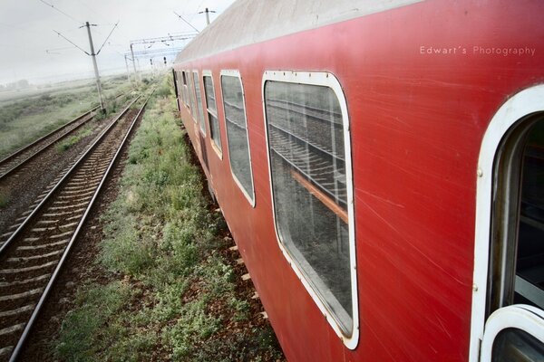 The train car and the rails going off into the distance