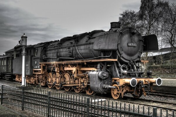 An old steam locomotive on the railway tracks. Retro train