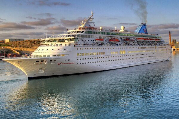 A huge white ship plows the expanses of the river