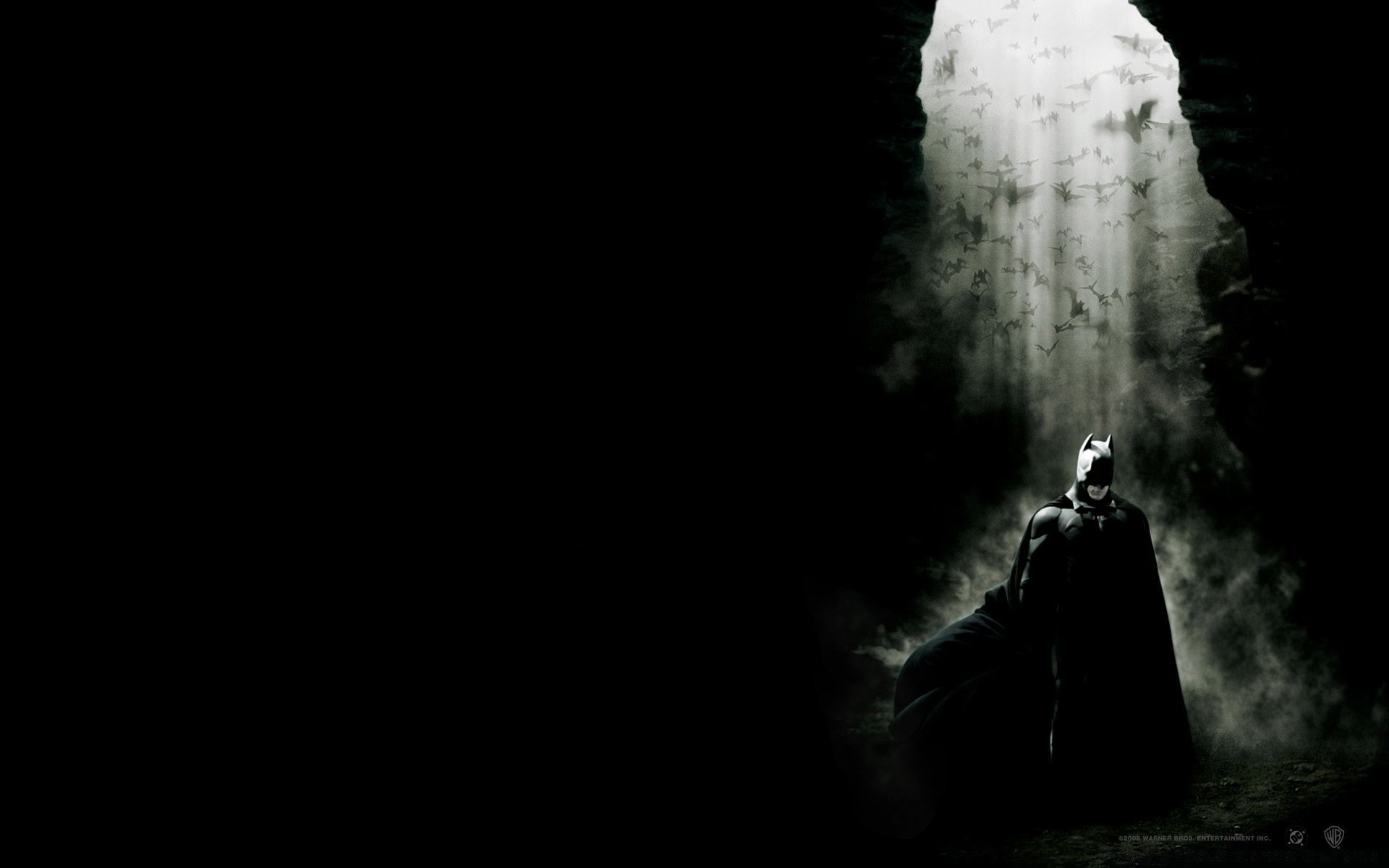 Image of Batman in a cave under the moon wallpaper