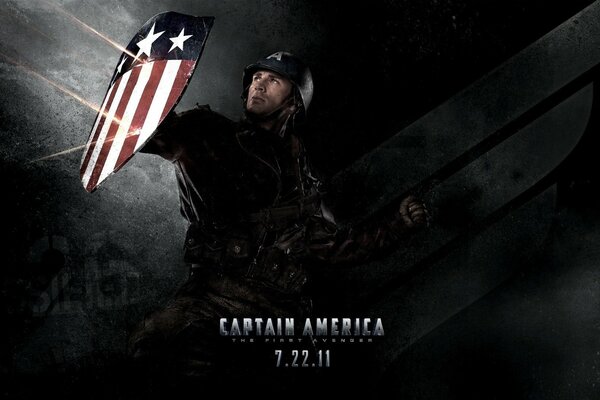 The first avenger with a shield in his hand on a black background