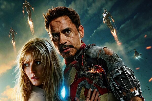 Iron man hugging a girl surrounded by flying superheroes