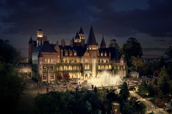 An old castle at night in the light of lanterns welcomes guests