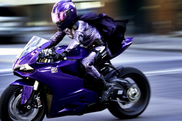 The motorcyclist rides along the road beautifully