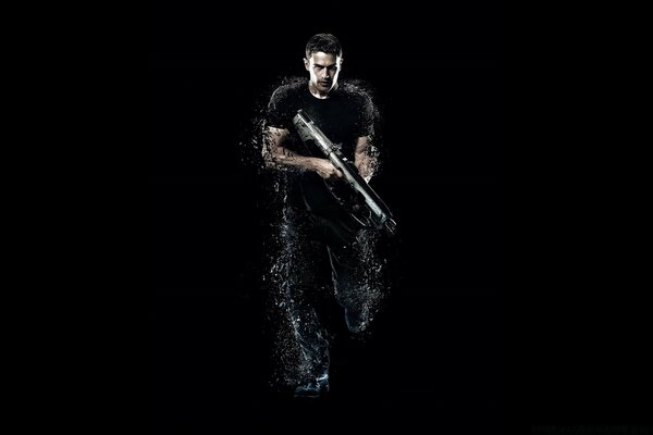 A man on a black background with a gun