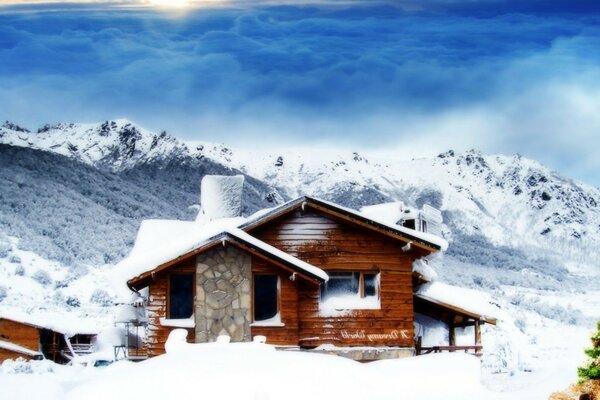 Chalet among snow-capped mountains, winter landscape