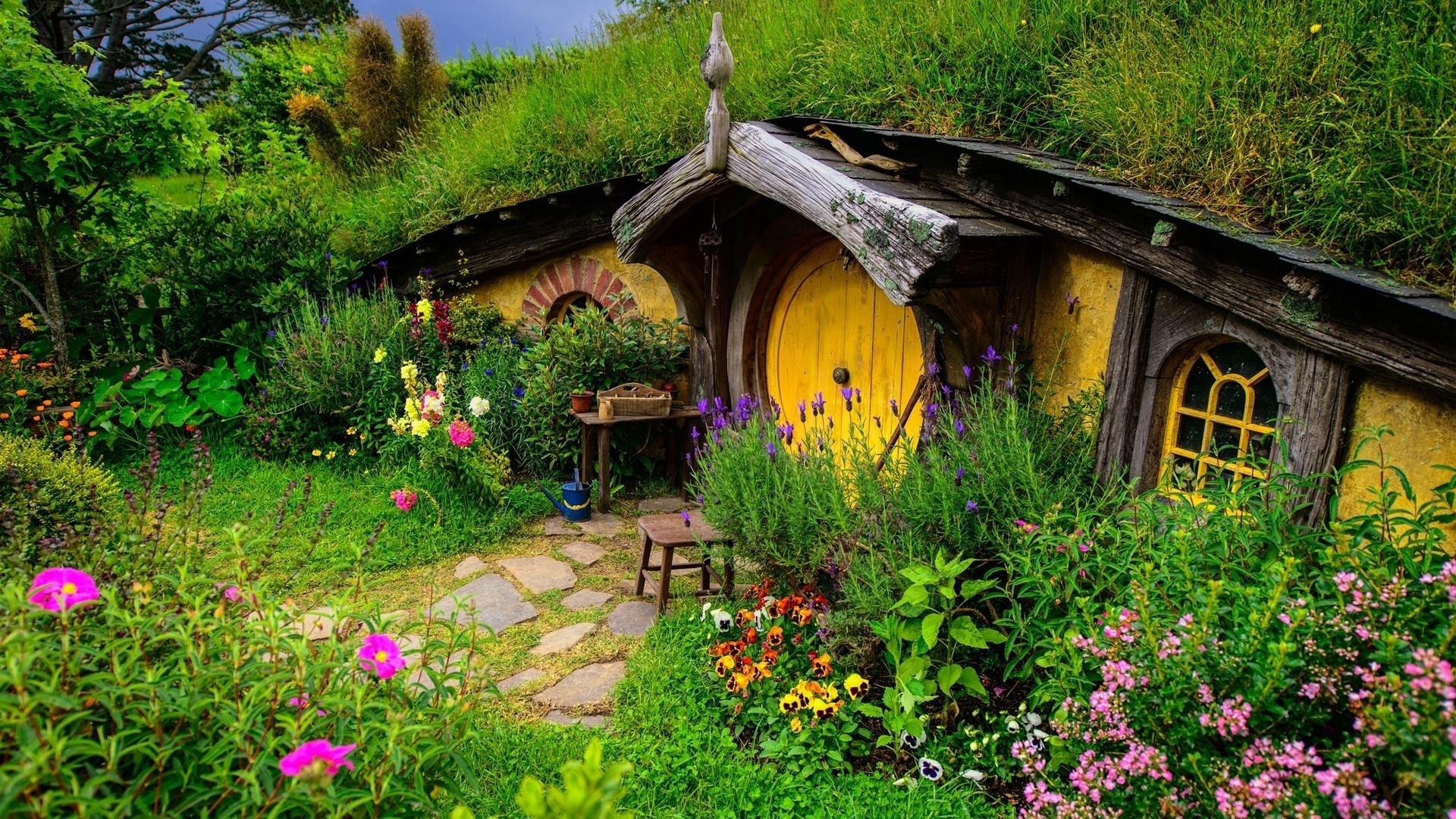 the hobbit flower garden house grass summer architecture building yard family wood lawn outdoors travel bungalow flora home nature